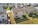 Aerial shot of a tan two-story home with patio and a grassy backyard in a community at 2522 Dalmahoy Ln, Fuquay Varina, NC 27526