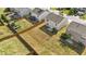 Aerial view showcases a home with large backyard featuring green and dry grass at 2522 Dalmahoy Ln, Fuquay Varina, NC 27526