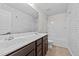 Modern bathroom featuring a double vanity, shower, and stylish accent wall at 2522 Dalmahoy Ln, Fuquay Varina, NC 27526