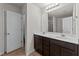 Bathroom with double sink vanity, modern lighting, and a door leading to the toilet and shower at 2522 Dalmahoy Ln, Fuquay Varina, NC 27526