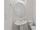 Clean half-bathroom with pedestal sink, toilet, and oval mirror at 2522 Dalmahoy Ln, Fuquay Varina, NC 27526