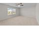 Bright bedroom featuring carpet floor, ceiling fan, and large windows with blinds at 2522 Dalmahoy Ln, Fuquay Varina, NC 27526