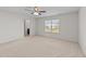 Bright bedroom featuring carpet floor, ceiling fan, and large windows with blinds at 2522 Dalmahoy Ln, Fuquay Varina, NC 27526