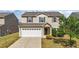 Two-story home featuring neutral siding, a two-car garage, and professionally landscaped front yard at 2522 Dalmahoy Ln, Fuquay Varina, NC 27526