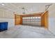 Spacious garage with high ceilings, a metal overhead door, and concrete floor at 2522 Dalmahoy Ln, Fuquay Varina, NC 27526