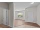 Open room concept with wood-look floors, large window, neutral paint, and light-colored tile flooring at 2522 Dalmahoy Ln, Fuquay Varina, NC 27526