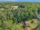 Aerial view of a home surrounded by mature trees with ball field nearby at 2608 Foxgate Dr, Raleigh, NC 27610