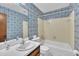 Bathroom features a blue patterned wall and shower/tub combo at 2608 Foxgate Dr, Raleigh, NC 27610