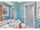 Bright bathroom with a shower featuring a tiled enclosure and a window at 2608 Foxgate Dr, Raleigh, NC 27610