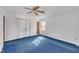 Bedroom with blue carpet, white walls, closet, and a window at 2608 Foxgate Dr, Raleigh, NC 27610