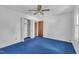 Bedroom featuring blue carpet, ceiling fan lighting, and a closet at 2608 Foxgate Dr, Raleigh, NC 27610