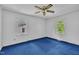 Bedroom with bright natural light, blue carpet, and ceiling fan lighting at 2608 Foxgate Dr, Raleigh, NC 27610