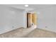 Bedroom with tan carpet, white walls, and a door leading to the hallway at 2608 Foxgate Dr, Raleigh, NC 27610
