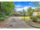 Street view of home with long driveway and mature landscaping, providing privacy and curb appeal at 2608 Foxgate Dr, Raleigh, NC 27610