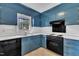 Kitchen with blue cabinets, white countertops, and stainless steel sink at 2608 Foxgate Dr, Raleigh, NC 27610