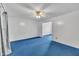 Living room with ample space, featuring a ceiling fan and blue carpet at 2608 Foxgate Dr, Raleigh, NC 27610