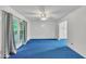 Bright living room featuring a large window, ceiling fan, and neutral paint at 2608 Foxgate Dr, Raleigh, NC 27610