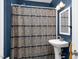 Bathroom with patterned shower curtain and modern sink at 302 Villa St, Rocky Mount, NC 27804
