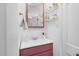 Bathroom featuring a modern vanity with a pink cabinet and stylish shelves for storage at 302 Villa St, Rocky Mount, NC 27804