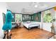 Stylish bedroom featuring dark green walls, hardwood floors, and a cozy sleeping area at 302 Villa St, Rocky Mount, NC 27804
