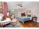 Cozy bedroom with hardwood floors, sitting area, and a bed dressed with plush pillows and a comfortable blanket at 302 Villa St, Rocky Mount, NC 27804
