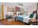 Bright bedroom boasts hardwood floors, comfortable furniture, and ample natural light through large windows at 302 Villa St, Rocky Mount, NC 27804