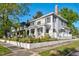 Charming two-story home with manicured lawn, flowers, and traditional front porch at 302 Villa St, Rocky Mount, NC 27804