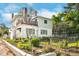 Back of home with wooden deck, beautiful foliage, garden, and white exterior paint at 302 Villa St, Rocky Mount, NC 27804