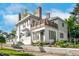 Two-story white home with large windows, a wooden deck, and beautiful landscaping at 302 Villa St, Rocky Mount, NC 27804