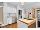 Charming kitchen with a breakfast bar, a dishwasher, and white cabinets at 302 Villa St, Rocky Mount, NC 27804
