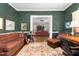 Cozy living room featuring dark green walls, opening into an adjoining room with comfortable seating at 302 Villa St, Rocky Mount, NC 27804