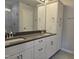 Bathroom with double sinks, white cabinets, gray countertop and tiled shower at 3026 Freewinds Way # 50, Cary, NC 27519