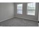 Bright bedroom features neutral walls, plush carpeting, and windows offering natural light at 3026 Freewinds Way # 50, Cary, NC 27519