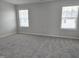 Carpeted bedroom with two windows at 3026 Freewinds Way # 50, Cary, NC 27519