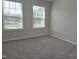 Carpeted bedroom featuring two windows at 3026 Freewinds Way # 50, Cary, NC 27519