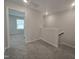 Upstairs hallway featuring a carpeted floor and an overlook with railings at 3026 Freewinds Way # 50, Cary, NC 27519