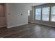 Living room with wood floors offers ample natural light from large windows and access to additional rooms at 3026 Freewinds Way # 50, Cary, NC 27519