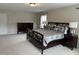 Spacious bedroom featuring a dark wood bed frame, nightstands, and a matching dresser at 3032 Kilarney Ridge Loop, Cary, NC 27511