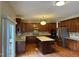 Open kitchen featuring a center island, granite counters, stainless appliances, and dark wood cabinetry at 3032 Kilarney Ridge Loop, Cary, NC 27511