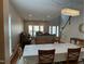 Open-concept living space with dining area, hardwood floors, and abundant natural light at 3032 Kilarney Ridge Loop, Cary, NC 27511
