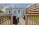 Outdoor deck area with comfortable chairs, a door to enter the house, and a privacy panel at 311 Oakley St, Graham, NC 27253