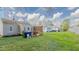 Exterior view of the house from the backyard, highlighting the spacious lawn and deck area at 311 Oakley St, Graham, NC 27253