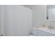 Clean, bright bathroom featuring a shower with a curtain, vanity with sink, and a functional toilet at 311 Oakley St, Graham, NC 27253