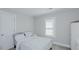 Serene bedroom with neutral tones, a comfortable bed, and natural light from the window at 311 Oakley St, Graham, NC 27253