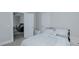 This bedroom features neutral tones and a doorway that leads to an adjacent living room at 311 Oakley St, Graham, NC 27253