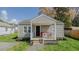 Charming single-story home with a welcoming front porch and well-maintained landscaping at 311 Oakley St, Graham, NC 27253