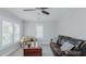 This inviting living room features a leather sofa, a ceiling fan, and a wooden chest coffee table at 311 Oakley St, Graham, NC 27253