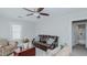 Comfortable living room with leather sofa, floral chair, ceiling fan and a wooden chest coffee table at 311 Oakley St, Graham, NC 27253
