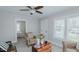 Cozy living room with a ceiling fan, a charming floral armchair, and a wooden chest as a coffee table at 311 Oakley St, Graham, NC 27253