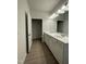Bathroom featuring double sink vanity, wood-look flooring and plenty of cabinet space at 322 Deodora Ln, Cameron, NC 28326